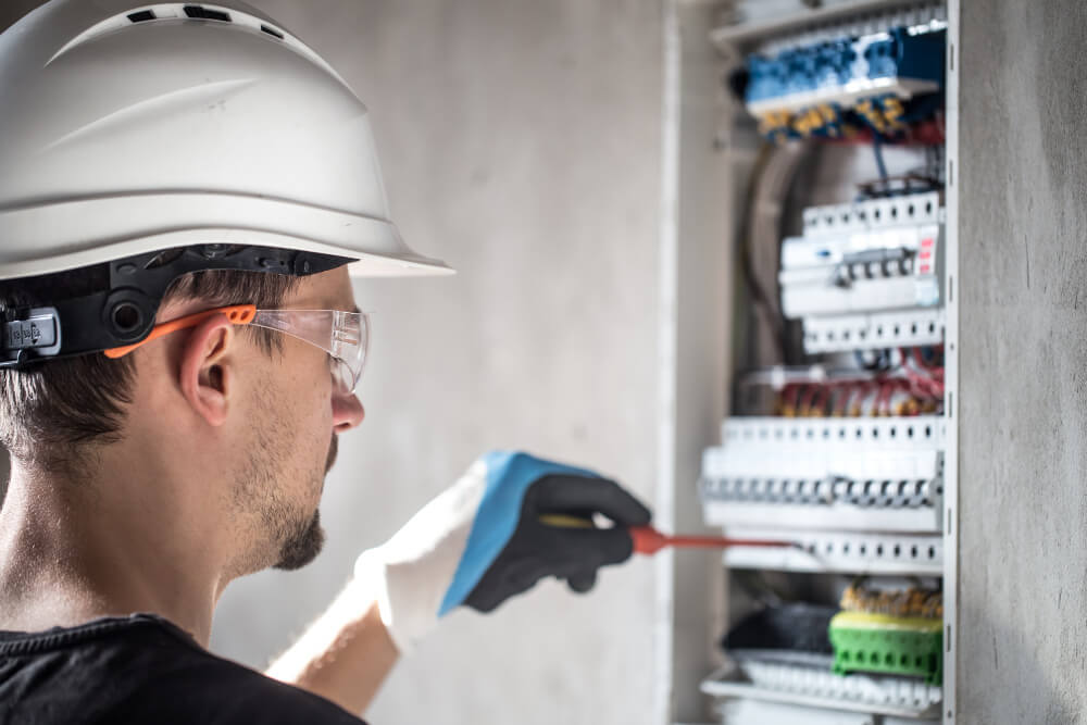 Electrical Wiring article man-electrical-technician-working-switchboard-with-fuses-installation-connection-electrical-equipment (1)